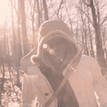 a person wearing a white coat and a tan hooded jacket
