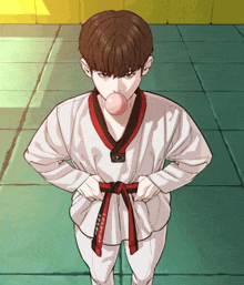 a young man in a taekwondo uniform blowing a pink bubble
