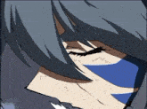 a close up of a person 's face with a blue stripe on their face