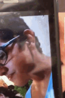 a close up of a person 's face on a cell phone screen