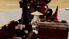 a lego character with a hat and a beard stands in front of a boat