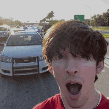 a man taking a selfie in front of a chevrolet