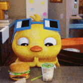 a cartoon duck wearing sunglasses sits at a table with a hamburger and a cup of milk