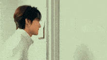 a close up of a person 's hand opening a door .