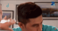 a close up of a man 's face with a zee tv logo on the bottom right