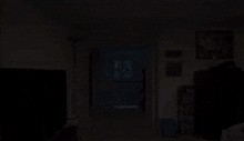 a man in a black sweatshirt with a skull on it is running through a hallway