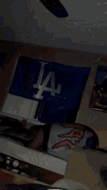 a person is laying in front of a la dodgers banner