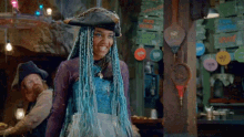 a woman with blue braids wearing a pirate hat