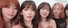a group of women are standing next to each other and looking at the camera