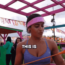 a woman holding a hula hoop with the words this is on her chest