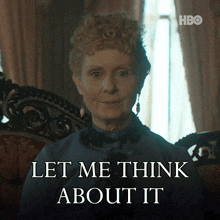 a woman sitting in a chair with the words let me think about it