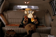 a picture of a person in a car with a monkey on their head
