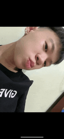 a close up of a person 's face with a shirt that says eve on it