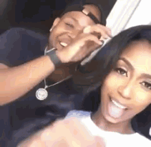 a man and a woman are sitting next to each other and smiling .