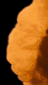 a close up of a piece of orange against a black background