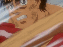 a man in red boxing gloves has a white s on his face