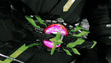 a person is holding a toy with green arrows pointing to it