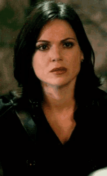 a close up of a woman wearing a black shirt