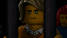 a lego man with a serious look on his face is behind bars