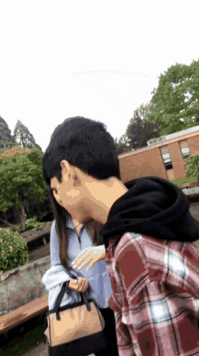 a man in a plaid shirt is talking to a woman