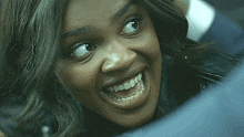 a close up of a woman 's face smiling
