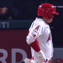 a baseball player wearing a red helmet with the letter a on the front