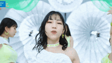 a girl with a choker on her neck stands in front of a sign that says front works