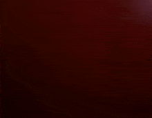 a robot is standing in the dark with a red light behind it