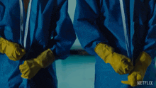 two people wearing blue suits and yellow gloves with a netflix logo