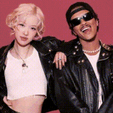 a man and a woman are posing for a picture and the woman is wearing a crop top