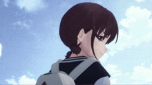a girl with a backpack is looking over her shoulder at the sky
