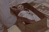 a woman is holding a doll in her arms in a crib .