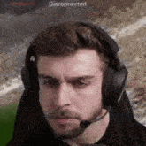 a man with a beard wearing headphones with a microphone .