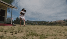 a woman in a white dress and high heels is running in the dirt