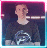 a young man wearing a black t-shirt with a helmet on it is standing in front of a neon frame .