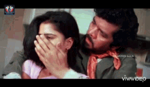 a man is covering a woman 's mouth with his hands in a movie .