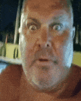 a man with a beard is making a funny face with his mouth open