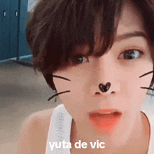 a close up of a person 's face with the words yuta de vic written above it