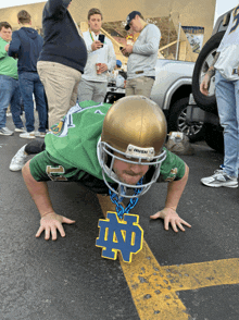 a man wearing a irish helmet is doing push ups on the ground