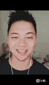 a man wearing ear buds looks at the camera
