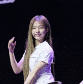 a woman in a white shirt is smiling in front of a copyright sign