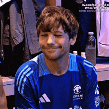 a man wearing a blue shirt that says soccer aid on it