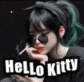 a girl with green hair is smoking a cigarette with the words hello kitty below her