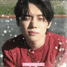 a man in a red shirt is surrounded by stars and says male y jjuni < 3