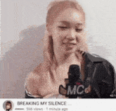 a video of a woman talking into a microphone with the words breaking my silence at the bottom