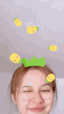 a woman wearing a green headband with pineapples on it and the words good morning on the bottom