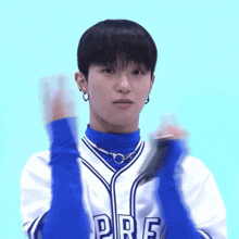 a young man wearing a blue and white jersey that says pre on it