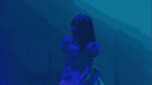 a woman in a purple dress with a tiara on her head is dancing on a stage