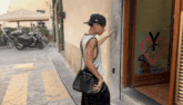 a man stands in front of a tattoo piercing store