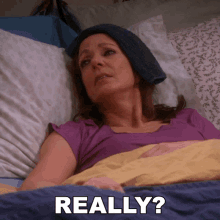 a woman laying in bed with a towel on her head and the words " really " written below her